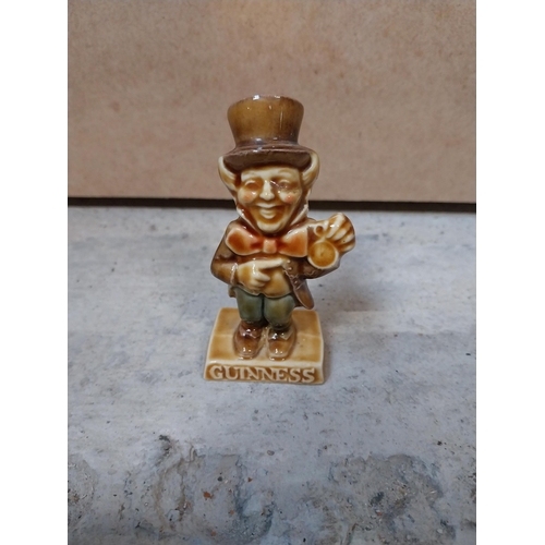 605 - Four miniature ceramic Guinness advertising figures. {9 cm H} approx.