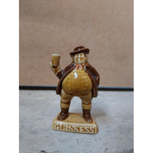 605 - Four miniature ceramic Guinness advertising figures. {9 cm H} approx.