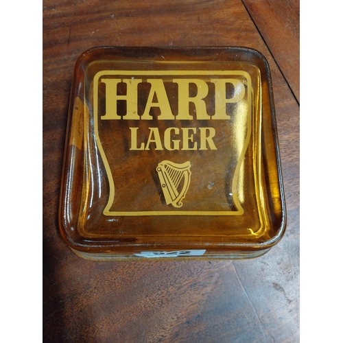 622 - Harp Lager amber glass advertising ashtray. {4 cm H x 15 cm W x 15 cm D}.