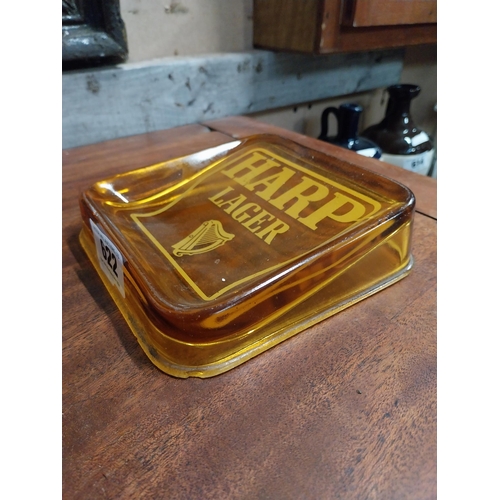 622 - Harp Lager amber glass advertising ashtray. {4 cm H x 15 cm W x 15 cm D}.