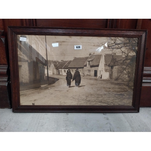 628 - Framed black and white print of rural Irish village. {55 cm H x 85 cm W}.