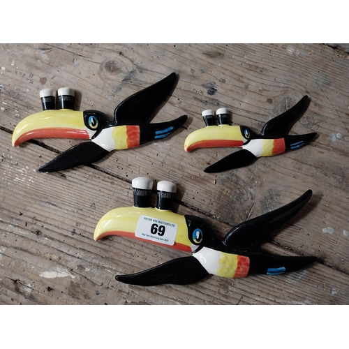 69 - Set of three ceramic Guinness Flying Toucans. {16 cm H x 27 cm W and 8 cm H x 17 cm W}.