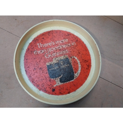 405 - Two Guinness tinplate advertising trays. {30 cm Dia.}.