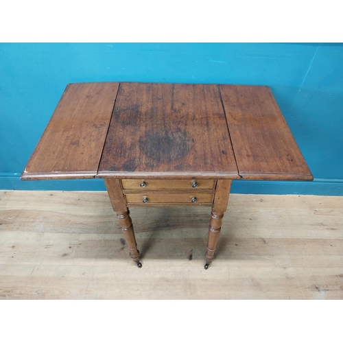 128 - 19th C. mahogany drop leaf lamp table with two drawers in the frieze raised on turned legs and brass... 