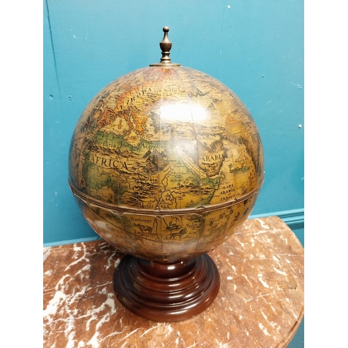 136 - Globe on wooden base in the form of a drinks' cabinet. {47 cm H x 32 cm Dia.}.