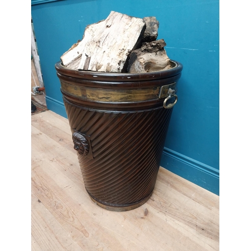 138 - Exceptional quality Irish mahogany brass bound spiral peat bucket decorated with lion's mask with or... 