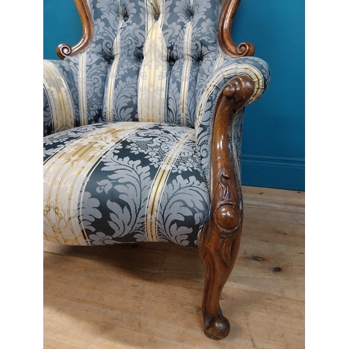 140 - Two Victorian mahogany and upholstered ladies and gents arm chairs raised on cabrioe legs {100 cm H ... 