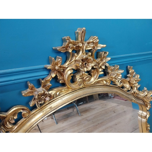 143 - Decorative gilt mirror {116 cm H x 120 cm W}.