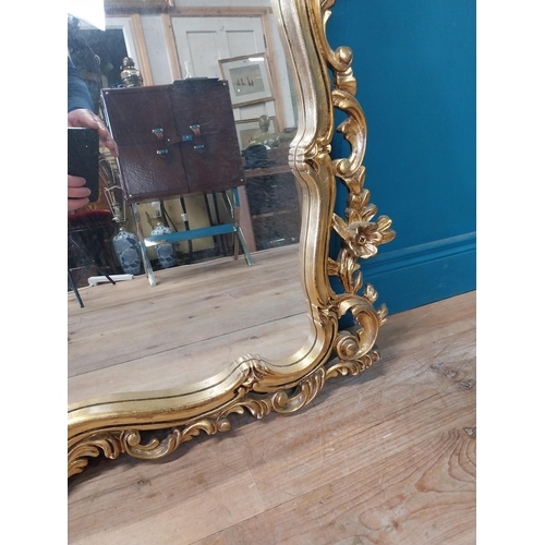 143 - Decorative gilt mirror {116 cm H x 120 cm W}.