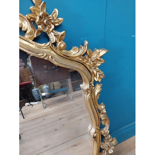 143 - Decorative gilt mirror {116 cm H x 120 cm W}.