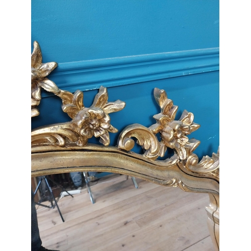 143 - Decorative gilt mirror {116 cm H x 120 cm W}.