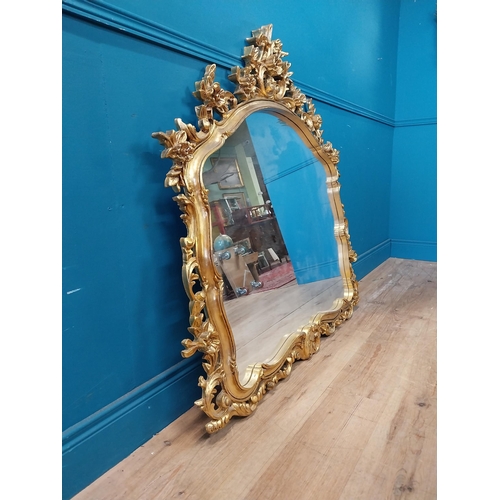 143 - Decorative gilt mirror {116 cm H x 120 cm W}.