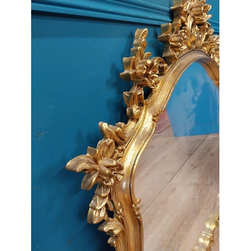 143 - Decorative gilt mirror {116 cm H x 120 cm W}.