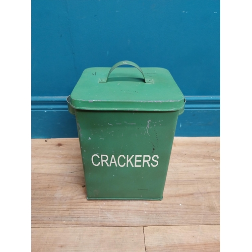 179 - Green painted metal Crackers lidded tin. {30 cm H x 24 cm W x 18 cm D}.