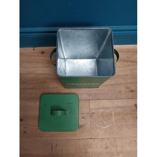 179 - Green painted metal Crackers lidded tin. {30 cm H x 24 cm W x 18 cm D}.