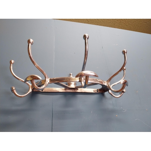 229 - Polished aluminium wall mounted hat and coat rack. {20 cm H x 65 cm W x 34 cm D].