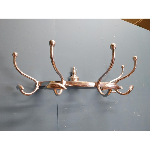 229 - Polished aluminium wall mounted hat and coat rack. {20 cm H x 65 cm W x 34 cm D].