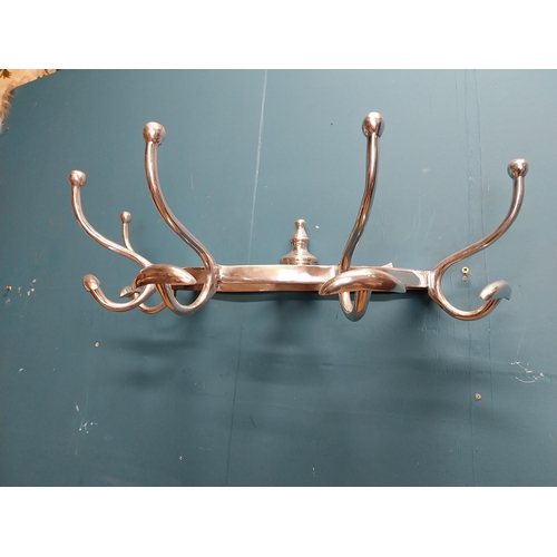 229 - Polished aluminium wall mounted hat and coat rack. {20 cm H x 65 cm W x 34 cm D].