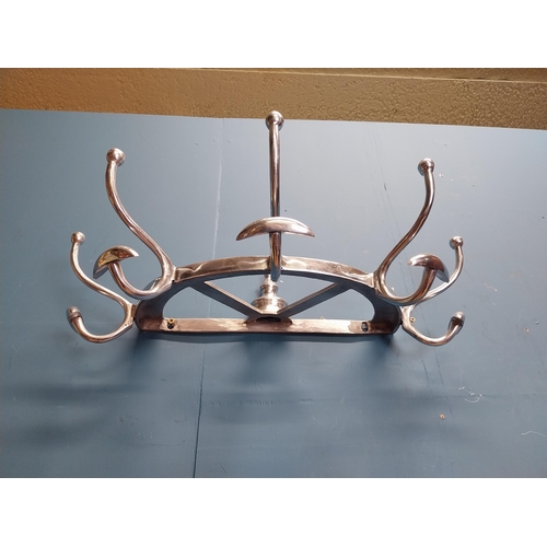 229 - Polished aluminium wall mounted hat and coat rack. {20 cm H x 65 cm W x 34 cm D].