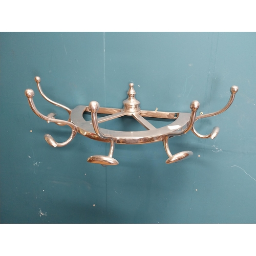 229 - Polished aluminium wall mounted hat and coat rack. {20 cm H x 65 cm W x 34 cm D].