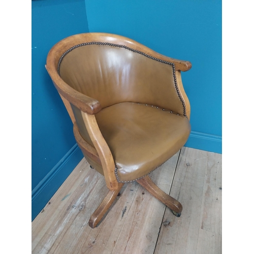 238 - 1940s oak and leather swivel office chair raised on four outswet legs and castors {83 cm H x 52 cm W... 