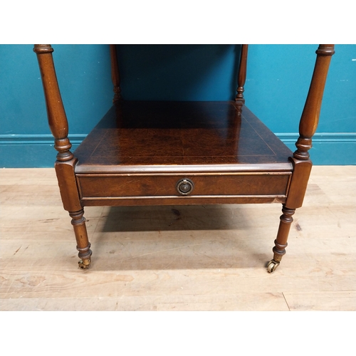 24 - Pair of burr walnut lamp tables with gallery back raised on turned columns and brass castors {67 cm ... 