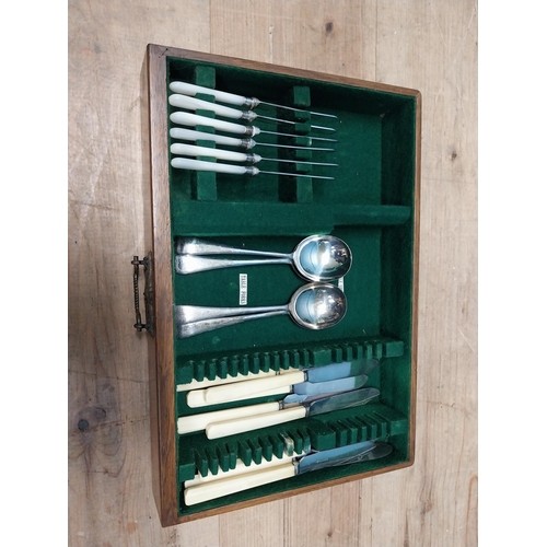 243 - Edwardian oak cased canteen of cutlery {22 cm H x 40 cm W x 29  cm D}.