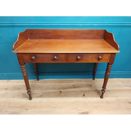 253 - 19th C. mahogany side table with gallery back and two drawers in the frieze raised on turned legs {9... 