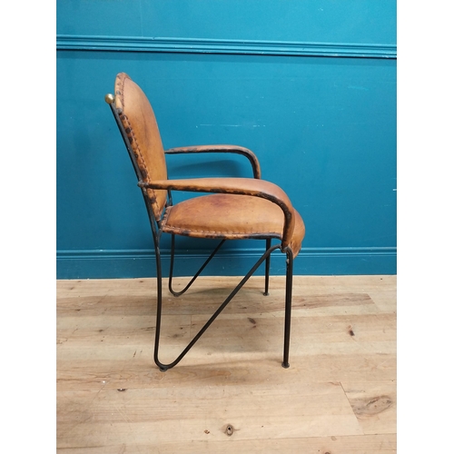 258 - Metal open arm chair with tanned leather upholsery {88 cm H x 65 cm W x 54 cm D}.