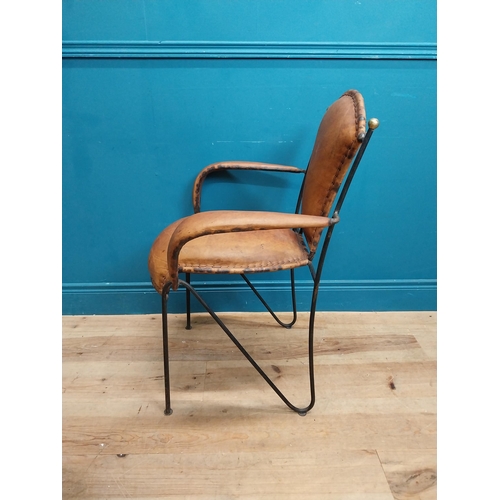 258 - Metal open arm chair with tanned leather upholsery {88 cm H x 65 cm W x 54 cm D}.