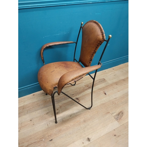 258 - Metal open arm chair with tanned leather upholsery {88 cm H x 65 cm W x 54 cm D}.