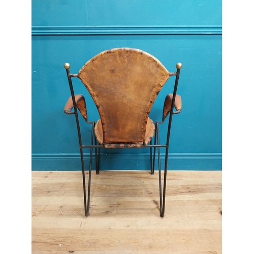 258 - Metal open arm chair with tanned leather upholsery {88 cm H x 65 cm W x 54 cm D}.