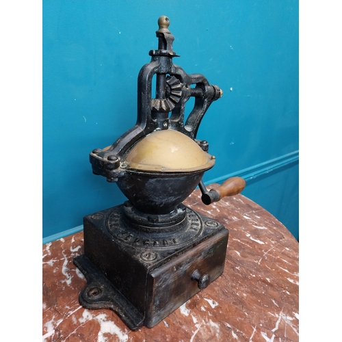 269 - Early 20th C. cast iron coffee grinder. {36 cm H x  36 cm W x 23 cm D}.