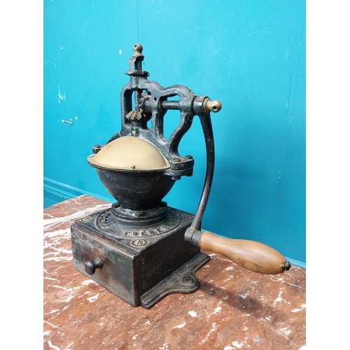 269 - Early 20th C. cast iron coffee grinder. {36 cm H x  36 cm W x 23 cm D}.