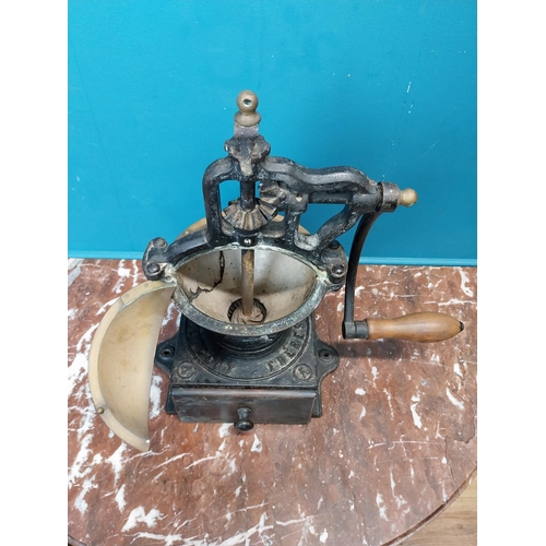 269 - Early 20th C. cast iron coffee grinder. {36 cm H x  36 cm W x 23 cm D}.