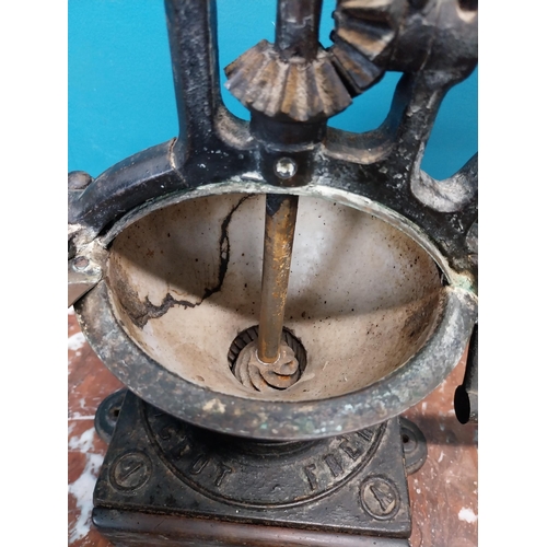 269 - Early 20th C. cast iron coffee grinder. {36 cm H x  36 cm W x 23 cm D}.