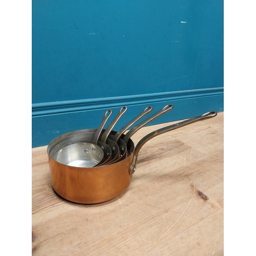 31 - Set of five graduated copper saucepans. {19 cm H  39 cm W x 20 cm D} to {11 cm H x 23 cm W x 12 cm D... 