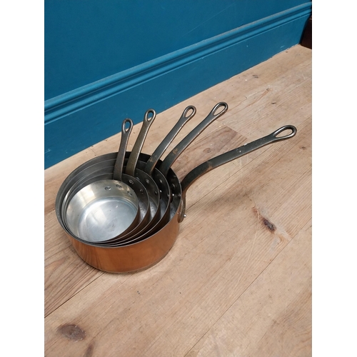 31 - Set of five graduated copper saucepans. {19 cm H  39 cm W x 20 cm D} to {11 cm H x 23 cm W x 12 cm D... 