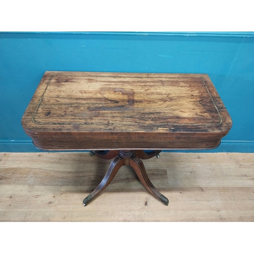 46 - Regency rosewood and brass inlay turn over leaf card table raised on turned column, four outswept fe... 