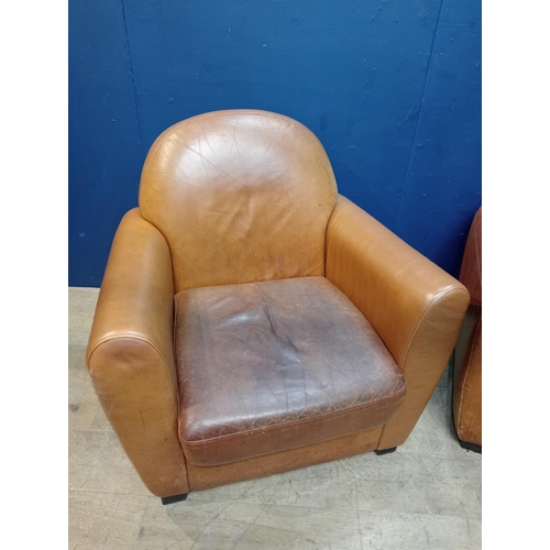 48 - Pair of tan leather club chairs { 83cm H X 86cm W X 80cm D }.