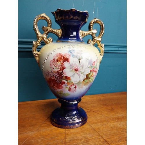 638 - Pair of ceramic vases with floral design and gilt handles {35 cm H x 24 cm W x 15 cm D}.