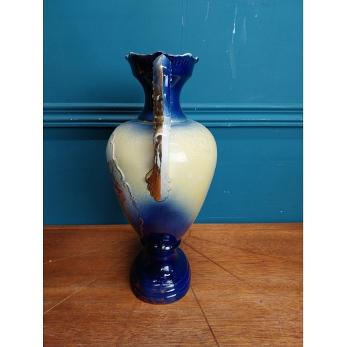 638 - Pair of ceramic vases with floral design and gilt handles {35 cm H x 24 cm W x 15 cm D}.