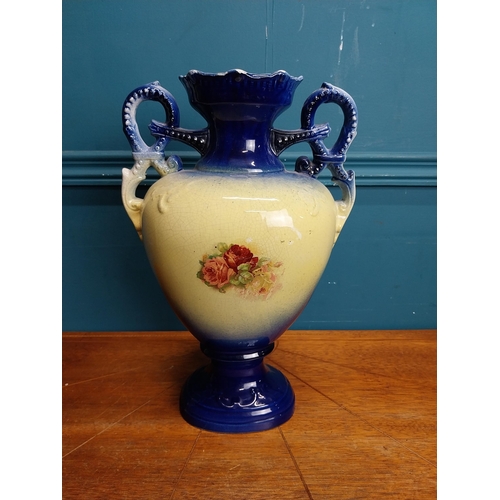 638 - Pair of ceramic vases with floral design and gilt handles {35 cm H x 24 cm W x 15 cm D}.