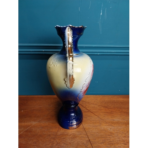 638 - Pair of ceramic vases with floral design and gilt handles {35 cm H x 24 cm W x 15 cm D}.