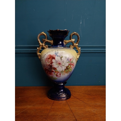 638 - Pair of ceramic vases with floral design and gilt handles {35 cm H x 24 cm W x 15 cm D}.