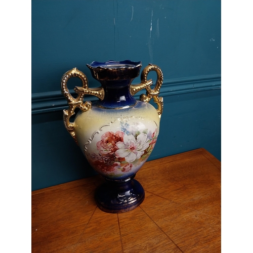 638 - Pair of ceramic vases with floral design and gilt handles {35 cm H x 24 cm W x 15 cm D}.