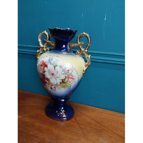 638 - Pair of ceramic vases with floral design and gilt handles {35 cm H x 24 cm W x 15 cm D}.