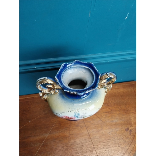 638 - Pair of ceramic vases with floral design and gilt handles {35 cm H x 24 cm W x 15 cm D}.