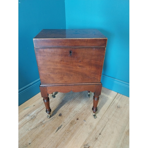 68 - Georgian mahogany cellarette raised on turned legs and castors {63 cm H x 49 cm W x 23 cm D}.