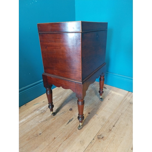 68 - Georgian mahogany cellarette raised on turned legs and castors {63 cm H x 49 cm W x 23 cm D}.